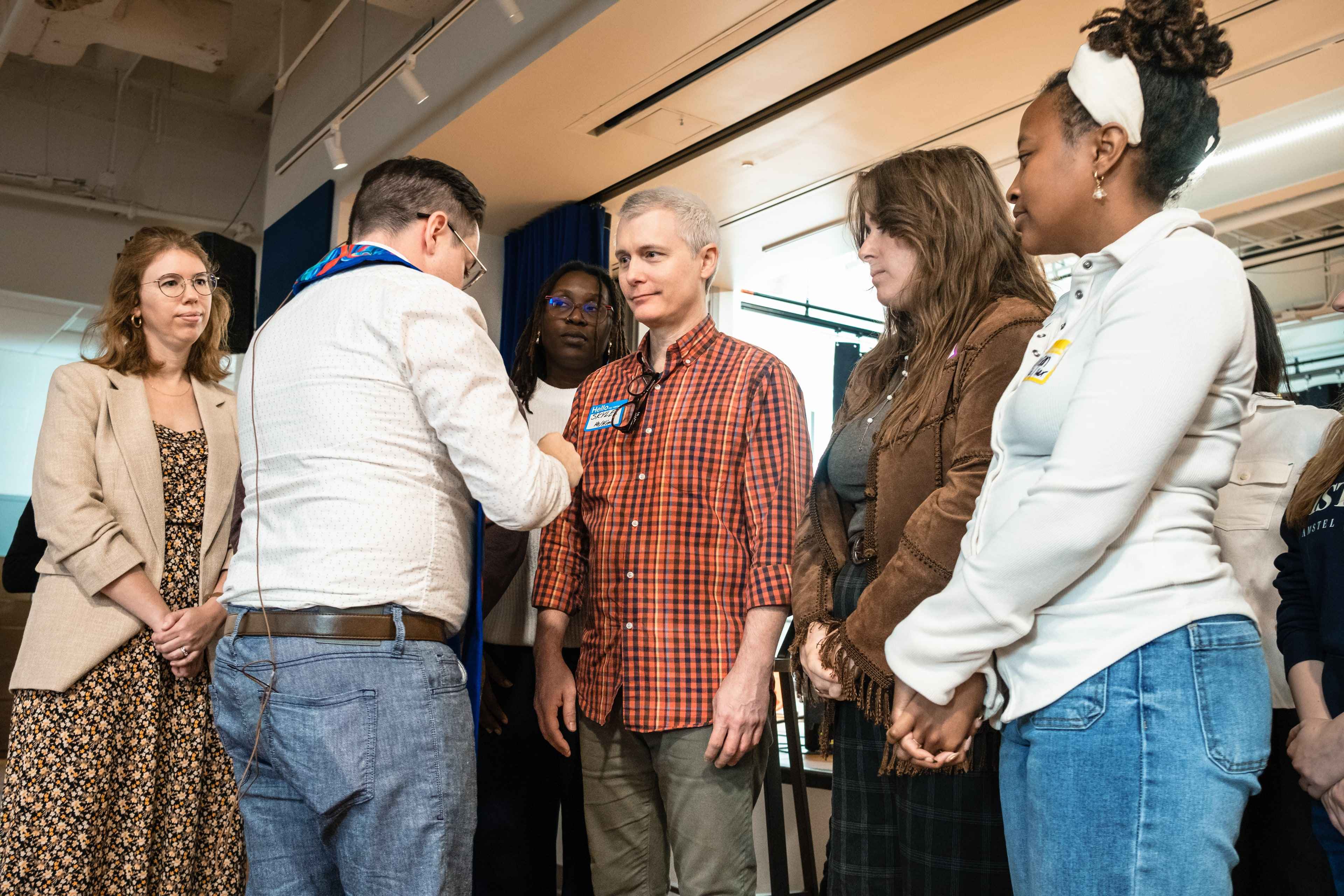 Church members lay hands on a group being commissioned for ministry.
